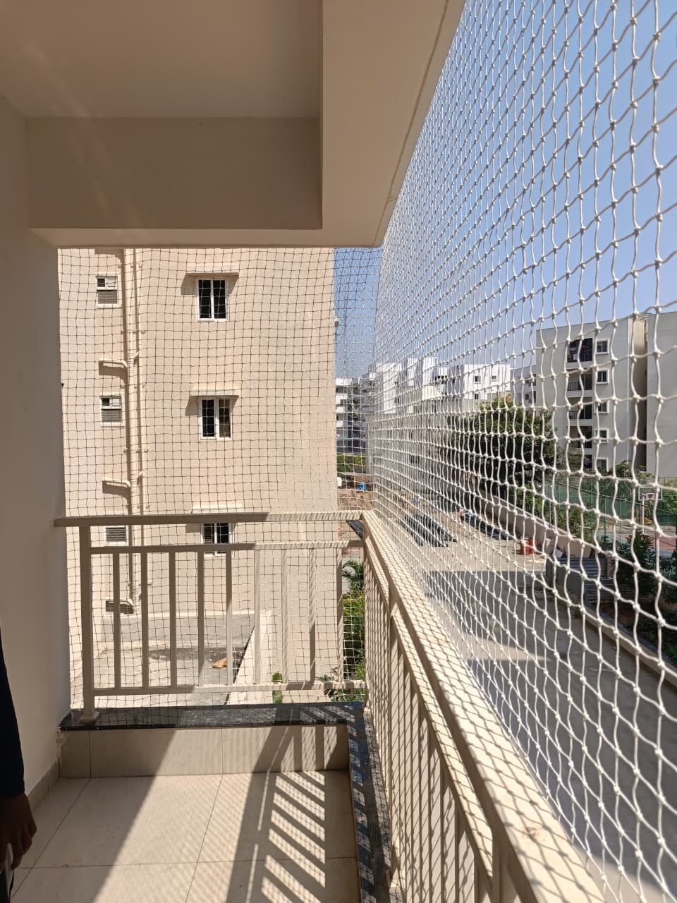 Yatri Enterprises installer fixing a balcony safety net